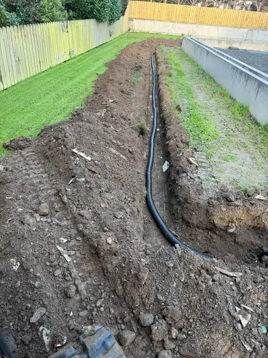 A garden drainage trench with the pipe laid in it