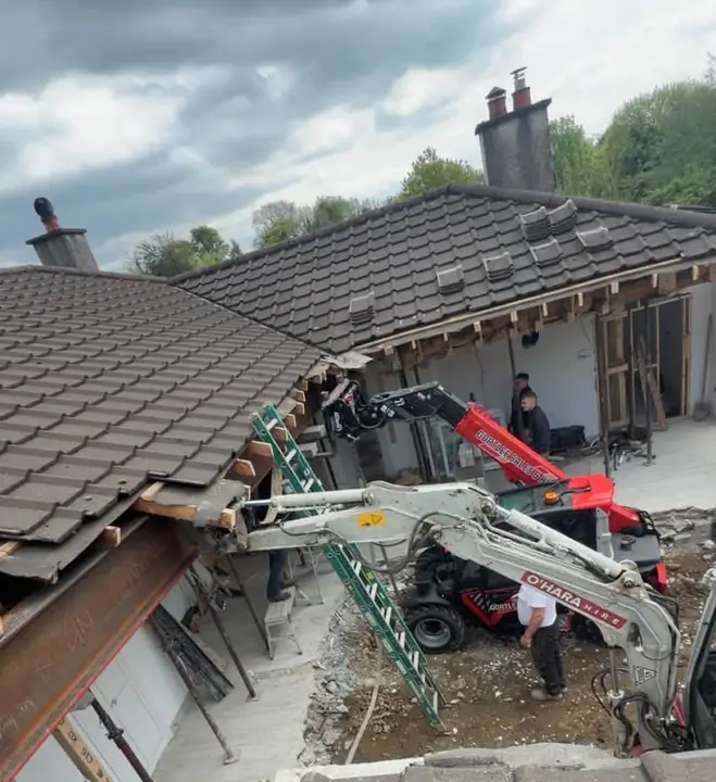 The back of the house opened up with machines on site
