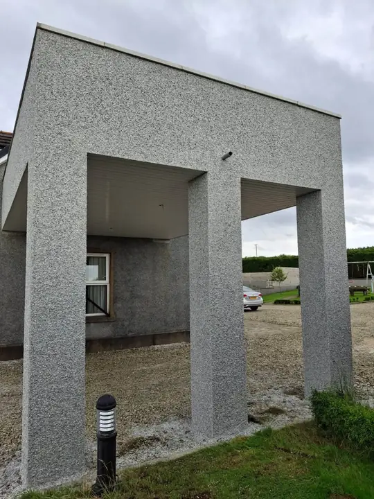 The balcony seen from the corner, showing the roughcast pillars