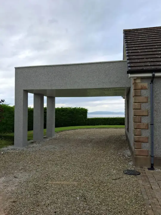 The new roughcast balcony on its pillars, with the lough in the distance